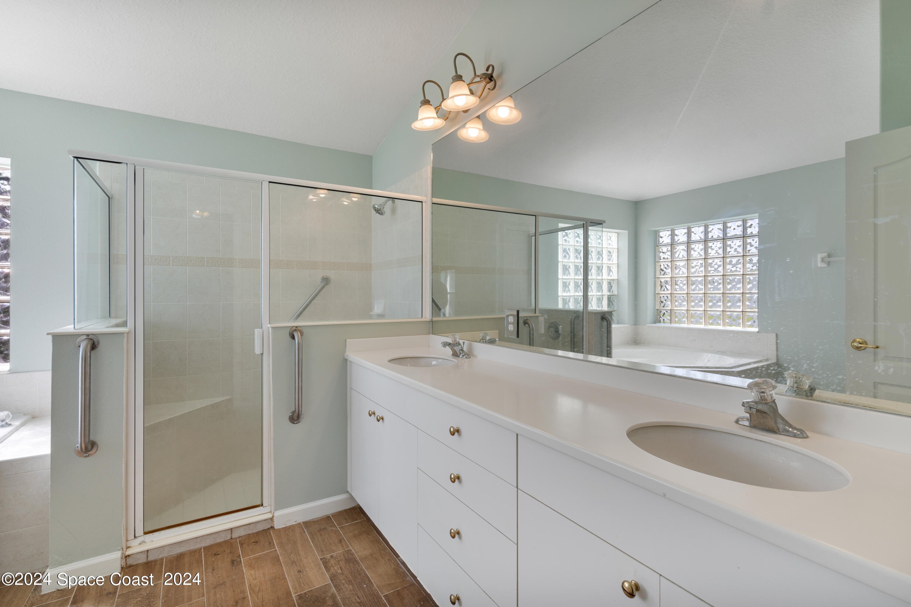 4220 Chardonnay Drive Rockledge, FL 32955 - Photo 29 of 51 a bathroom with a double vanity sink mirror and shower