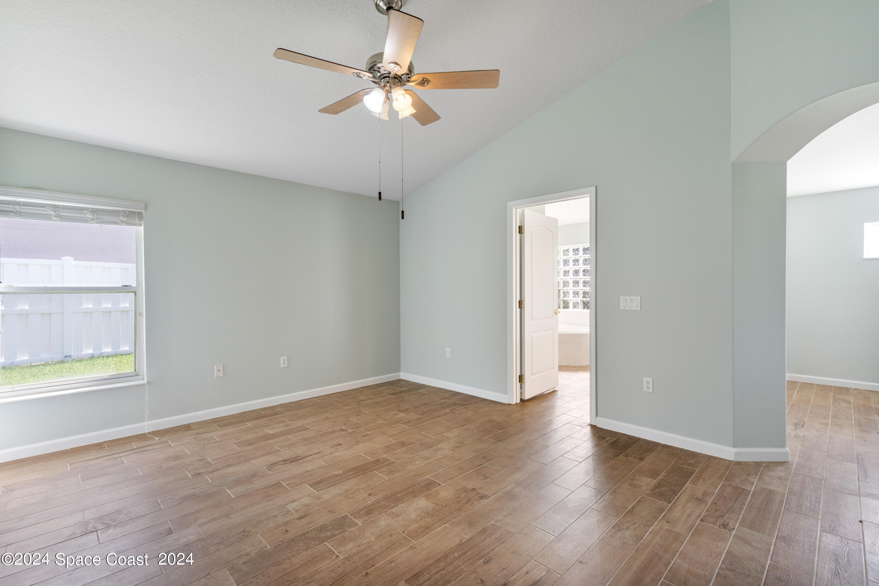 4220 Chardonnay Drive Rockledge, FL 32955 - Photo 30 of 51 wooden floor in an empty room with a window