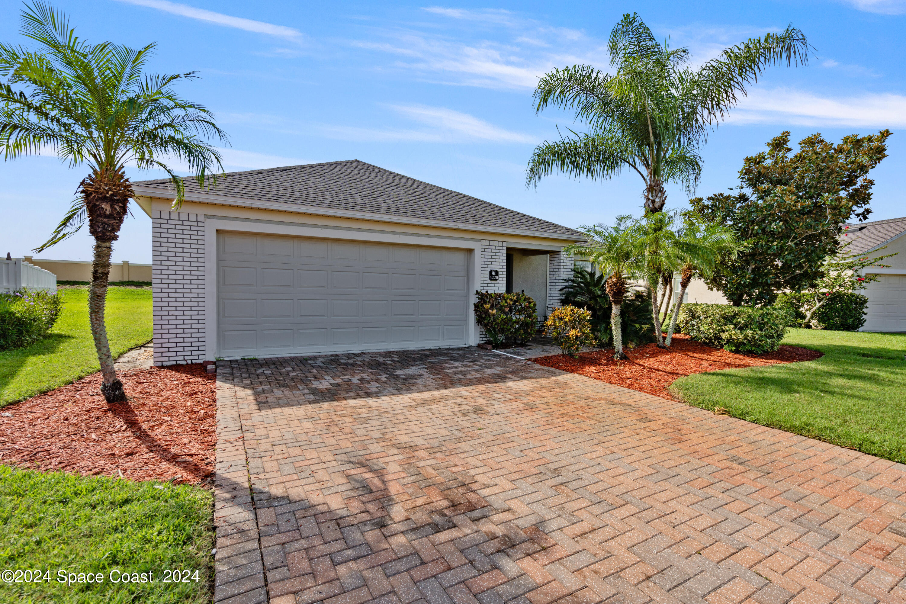 4220 Chardonnay Drive Rockledge, FL 32955 - Photo 4 of 51 a front view of house with yard and trees around