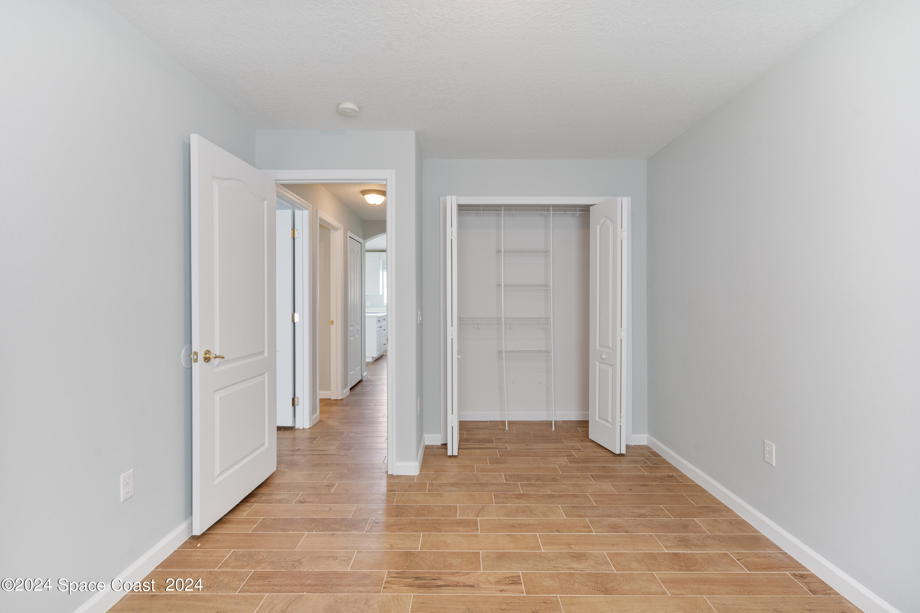 4220 Chardonnay Drive Rockledge, FL 32955 - Photo 42 of 51 a view of a hallway with wooden shelves