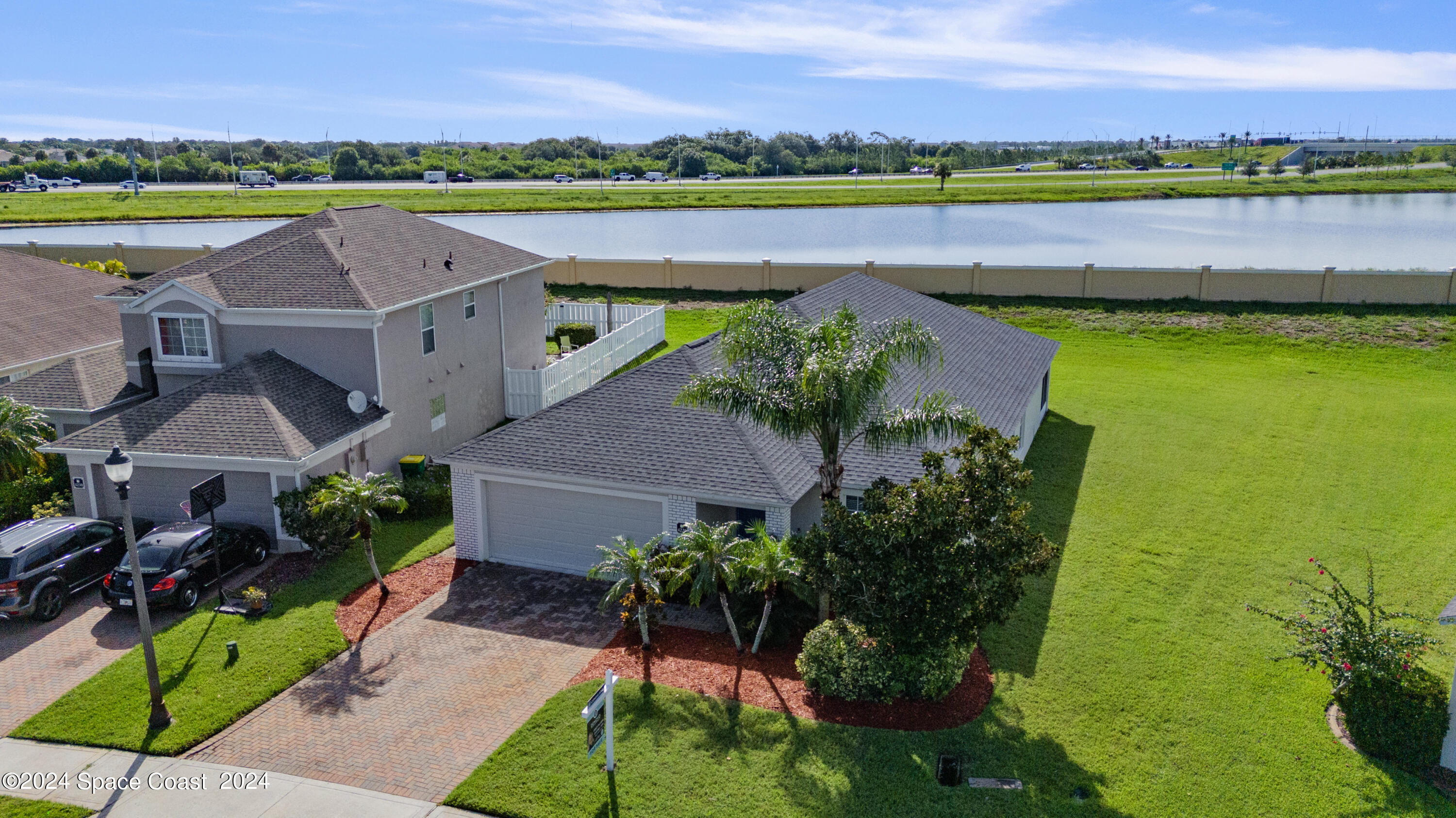 4220 Chardonnay Drive Rockledge, FL 32955 - Photo 45 of 51 an aerial view of a house with a garden and lake view