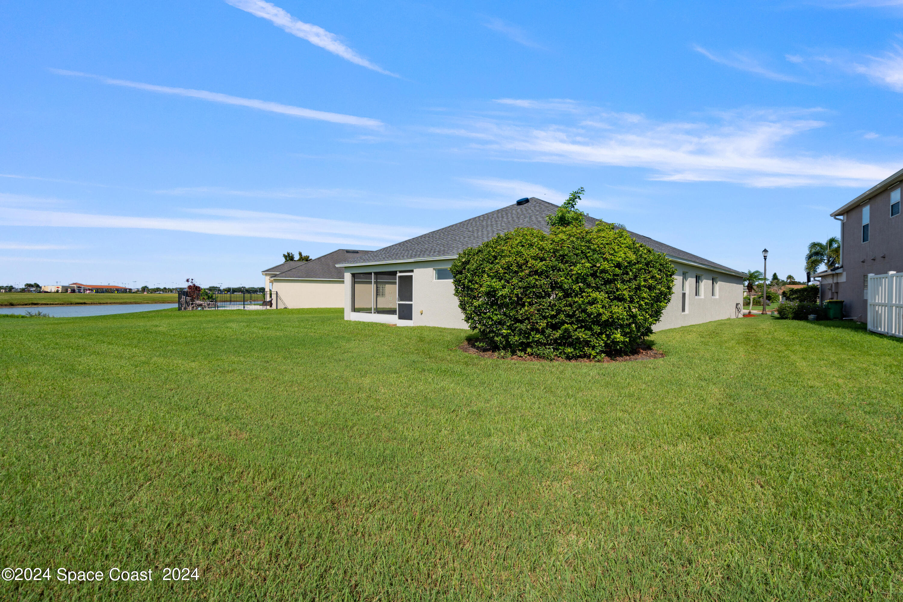 4220 Chardonnay Drive Rockledge, FL 32955 - Photo 50 of 51 a view of a big yard with plants and a large tree