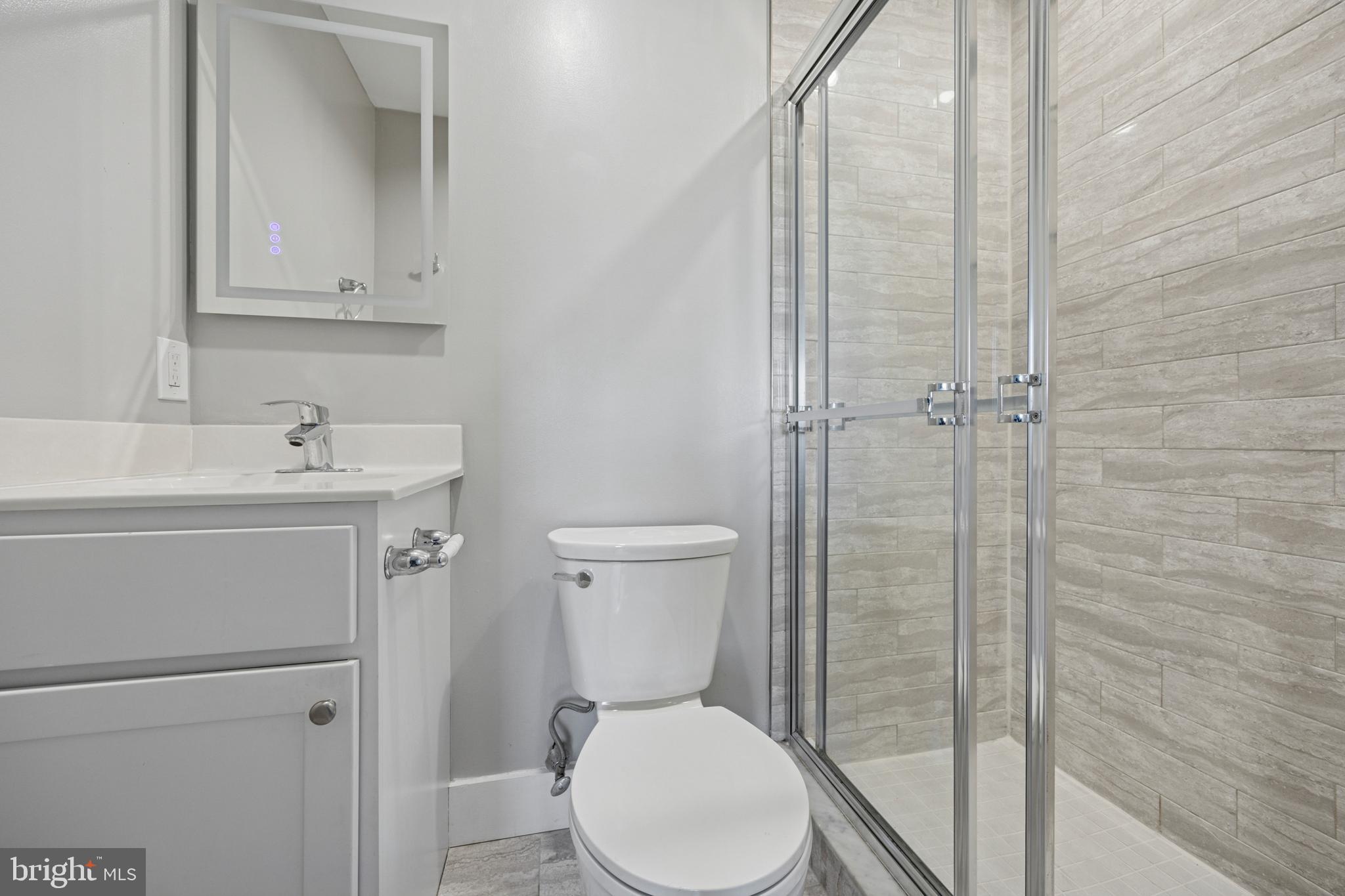 502 Gerhard Street, Unit J Philadelphia, PA 19128 - Photo 14 of 25 a bathroom with a sink a toilet and shower