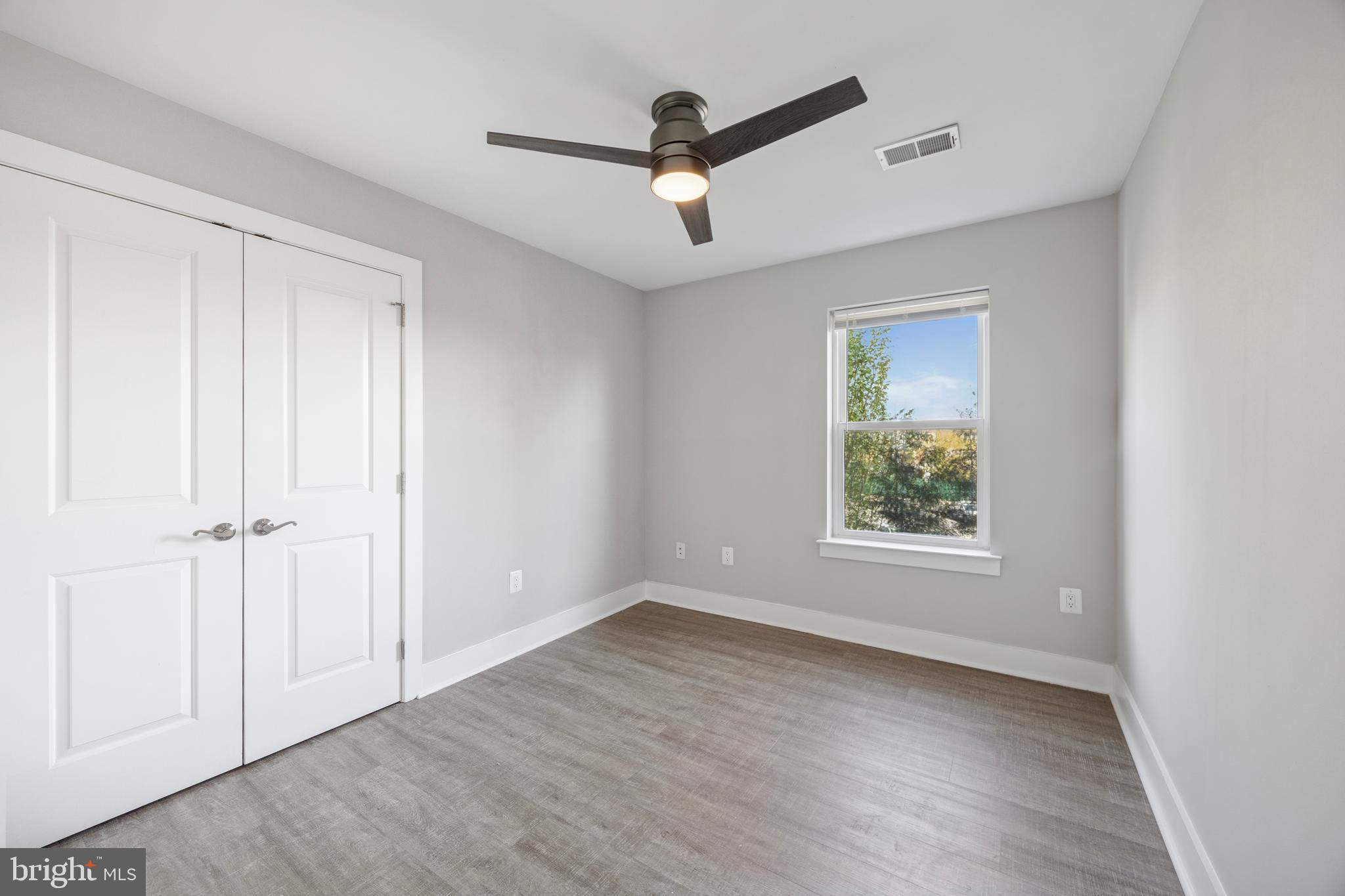 502 Gerhard Street, Unit J Philadelphia, PA 19128 - Photo 15 of 25 wooden floor in an empty room with a window