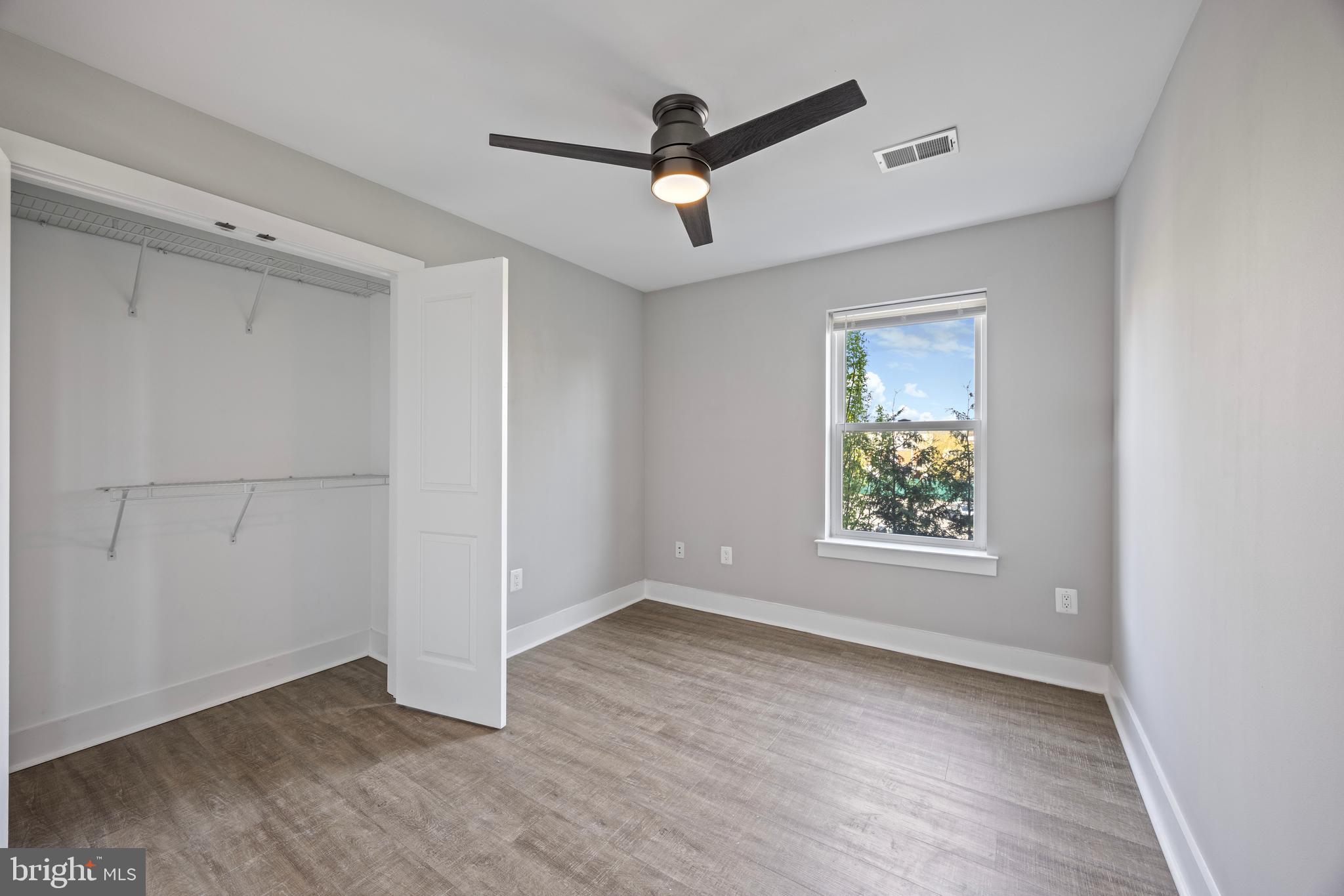 502 Gerhard Street, Unit J Philadelphia, PA 19128 - Photo 16 of 25 an empty room with wooden floor and windows