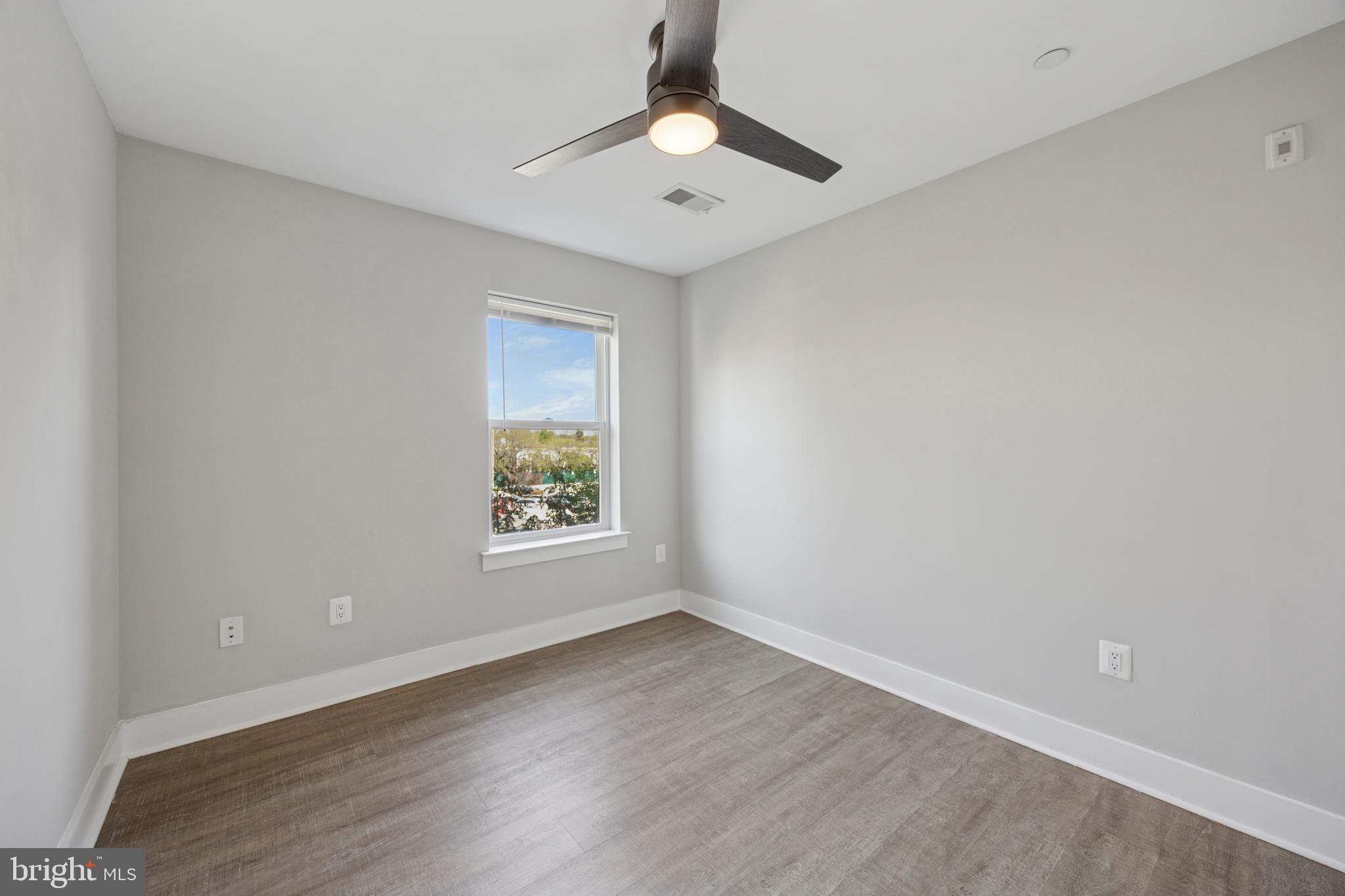 502 Gerhard Street, Unit J Philadelphia, PA 19128 - Photo 17 of 25 wooden floor in an empty room with a window