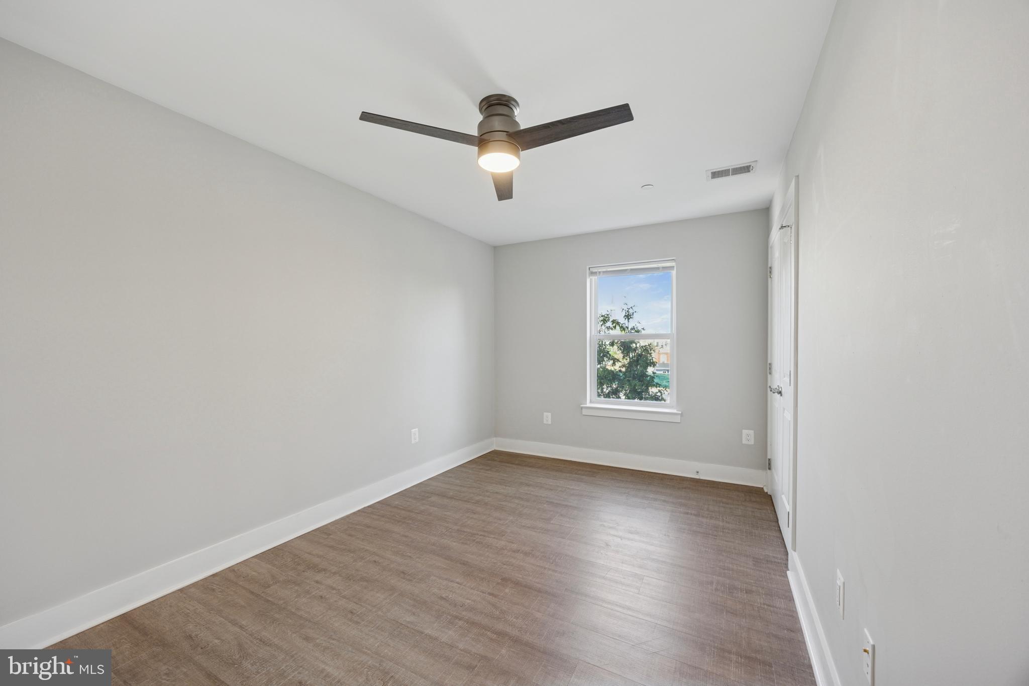 502 Gerhard Street, Unit J Philadelphia, PA 19128 - Photo 18 of 25 wooden floor in an empty room with a window
