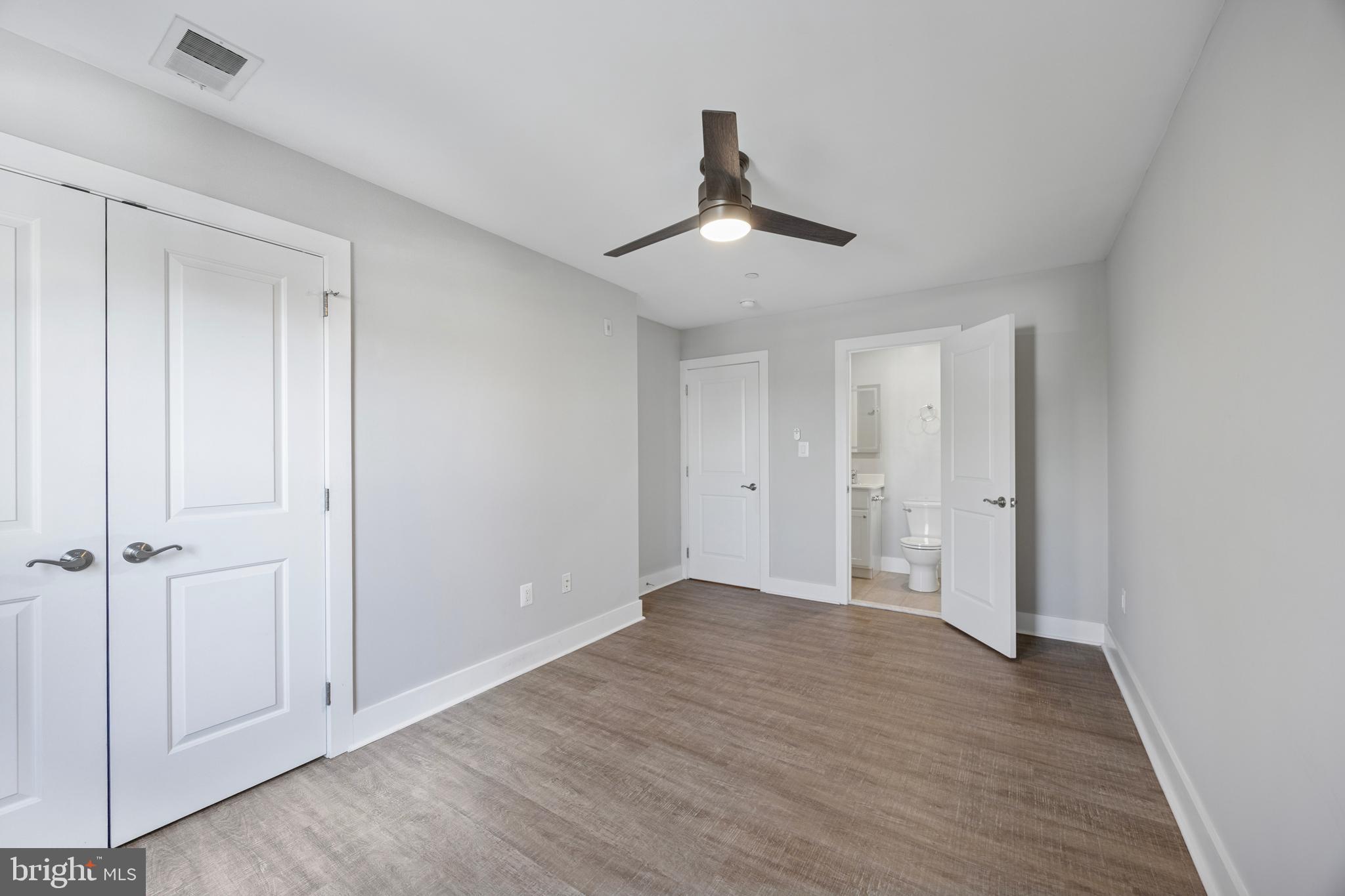502 Gerhard Street, Unit J Philadelphia, PA 19128 - Photo 20 of 25 a view of an empty room with wooden floor and a ceiling fan