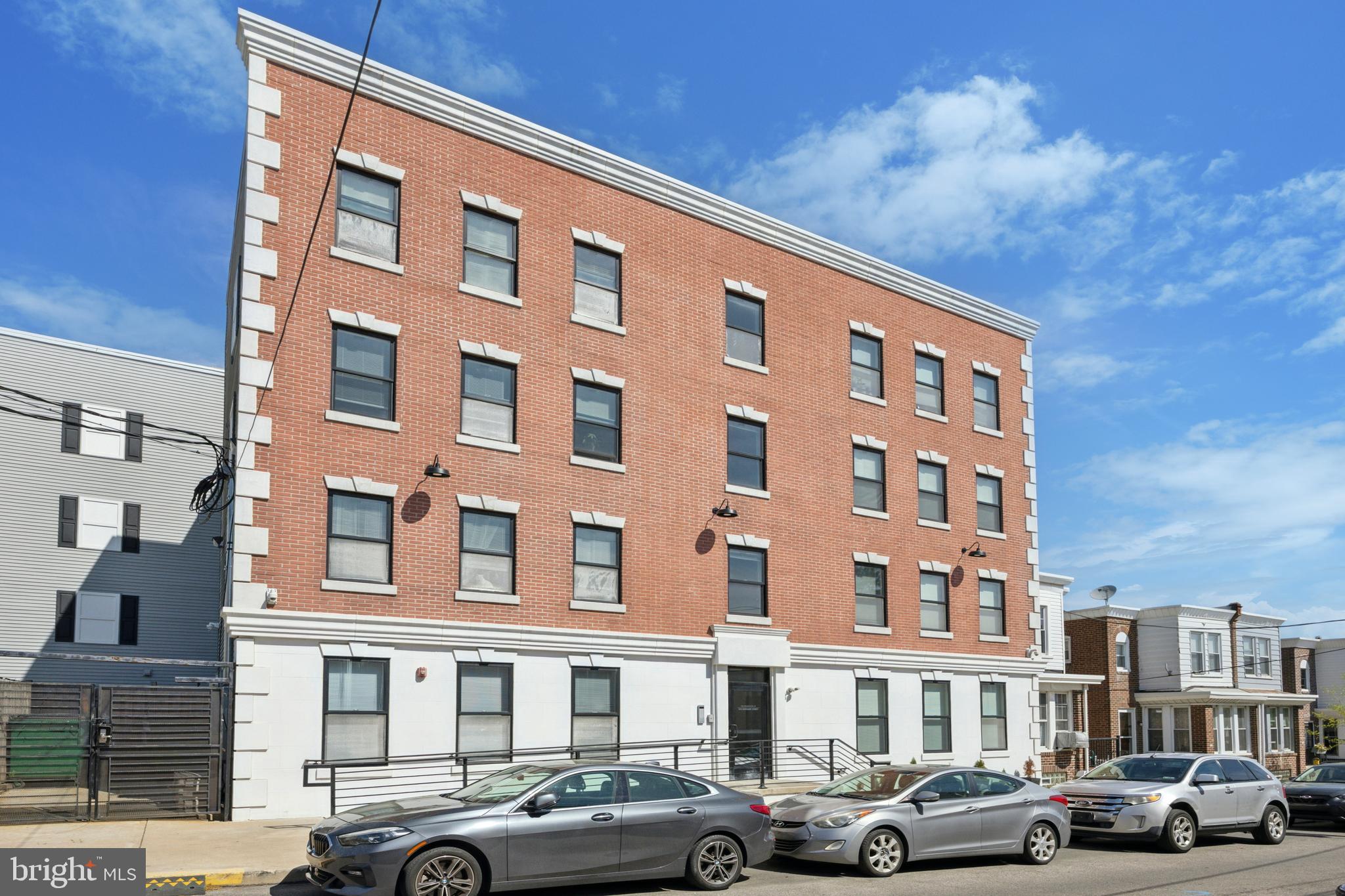 502 Gerhard Street, Unit J Philadelphia, PA 19128 - Photo 21 of 25 a front view of a building with lot of cars parked