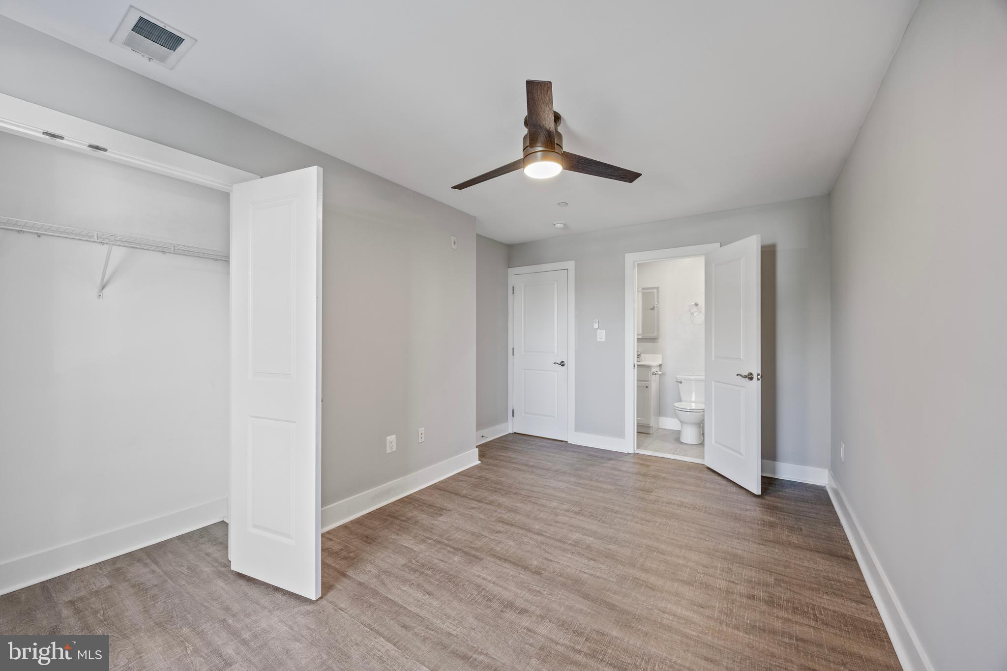 502 Gerhard Street, Unit J Philadelphia, PA 19128 - Photo 22 of 25 a view of an empty room with wooden floor and a ceiling fan