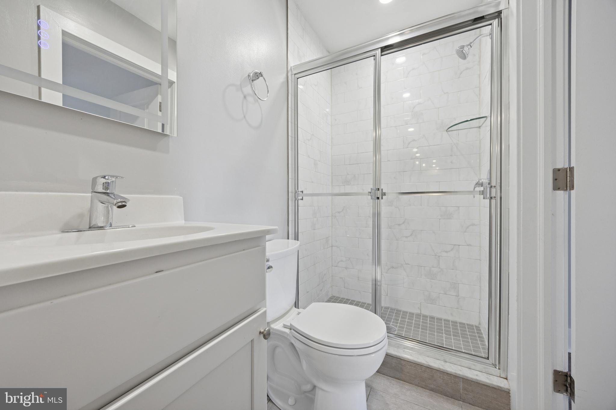502 Gerhard Street, Unit J Philadelphia, PA 19128 - Photo 24 of 25 a bathroom with a shower a toilet and a sink