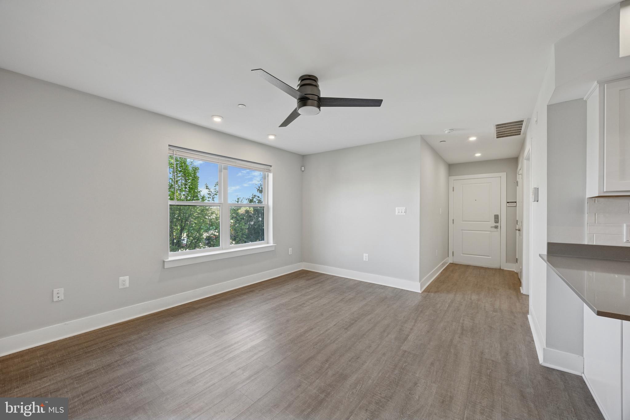 502 Gerhard Street, Unit J Philadelphia, PA 19128 - Photo 3 of 25 a view of an empty room with wooden floor and a window