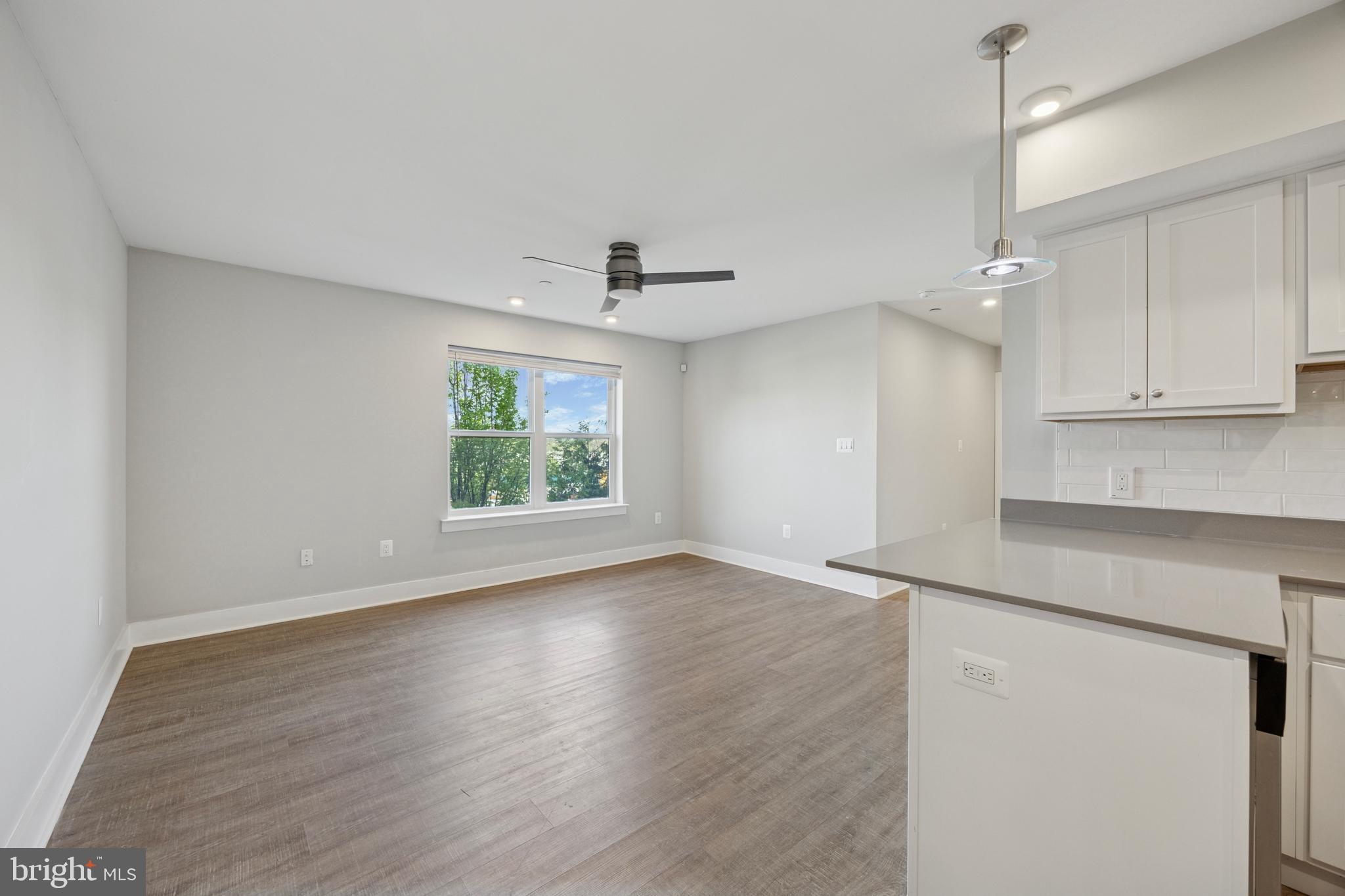 502 Gerhard Street, Unit J Philadelphia, PA 19128 - Photo 4 of 25 an empty room with wooden floor and windows