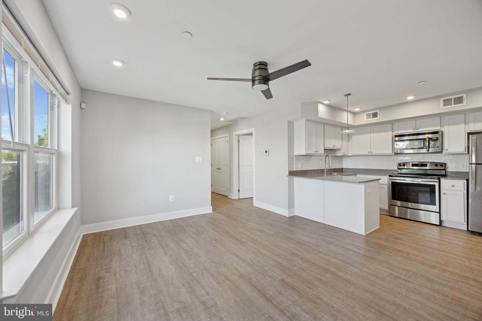 502 Gerhard Street, Unit J Philadelphia, PA 19128 - Photo 5 of 25 a view of kitchen with granite countertop stainless steel appliances and wooden floor