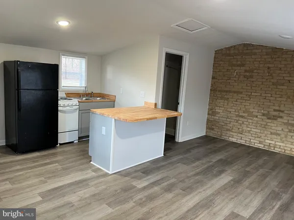 a kitchen with stainless steel appliances a refrigerator and a stove