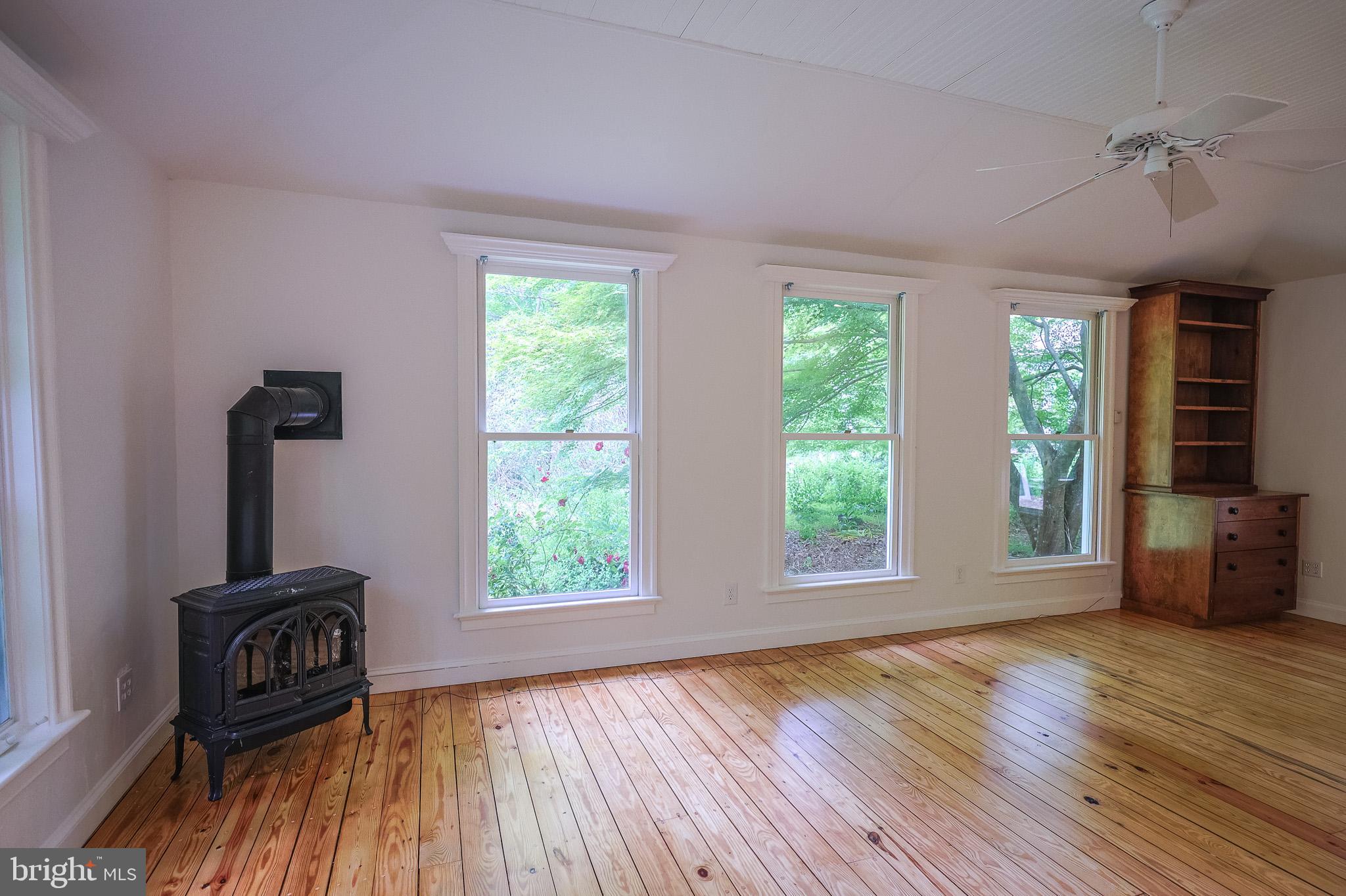 98 Swindler Hollow Road Sperryville, VA 22740 - Photo 15 of 25 wooden floor chandelier and windows in a room