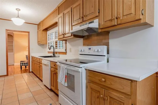 a kitchen with stainless steel appliances granite countertop a stove and a refrigerator
