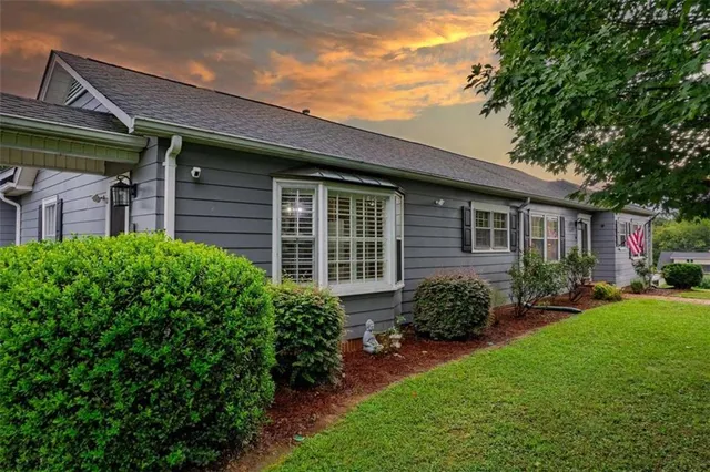 a front view of a house with garden
