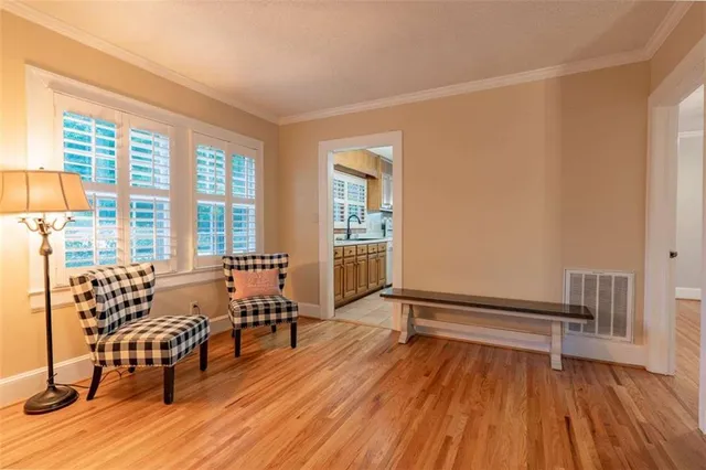 a view of a livingroom with furniture wooden floor and windows