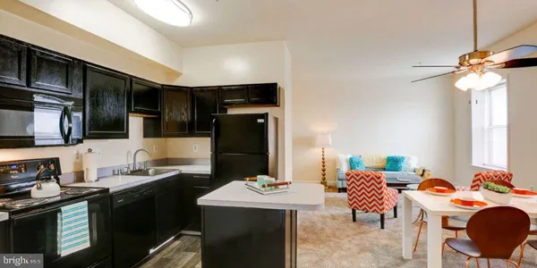 a kitchen with stainless steel appliances kitchen island granite countertop a sink and cabinets