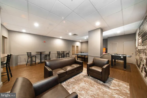 a living room with furniture a rug and kitchen view