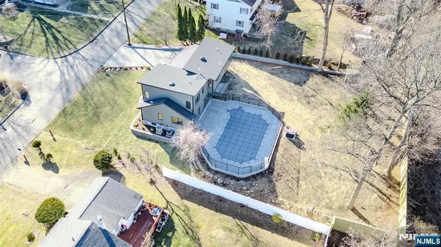 an aerial view of a house with a swimming pool