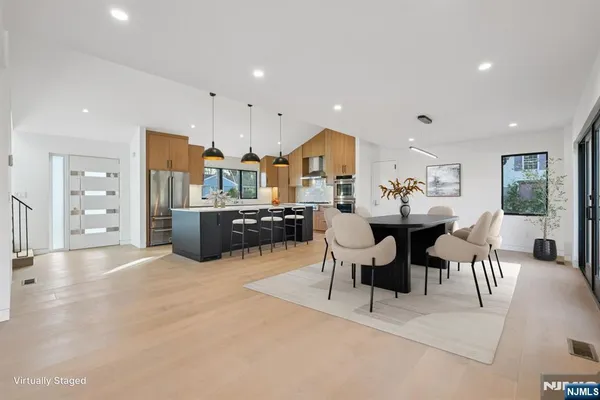 a large kitchen with a table and chairs