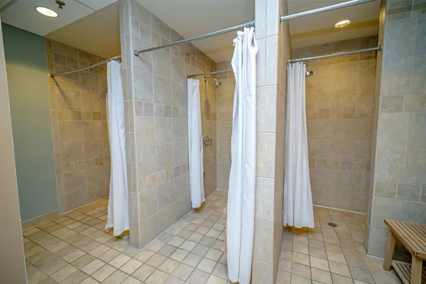 a room with gym equipment and large windows