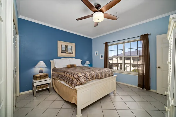 a spacious bedroom with a bed and a ceiling fan