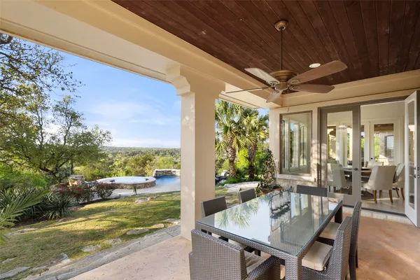 a backyard of a house with table and chairs