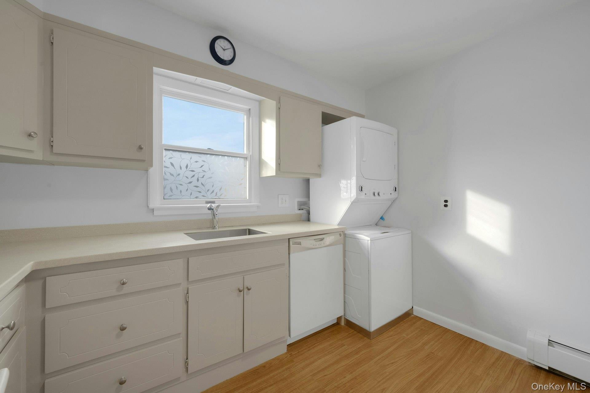 52 Post Place, Unit 2 Harrison, NY 10528 - Photo 12 of 23 a kitchen with a sink cabinets and wooden floor