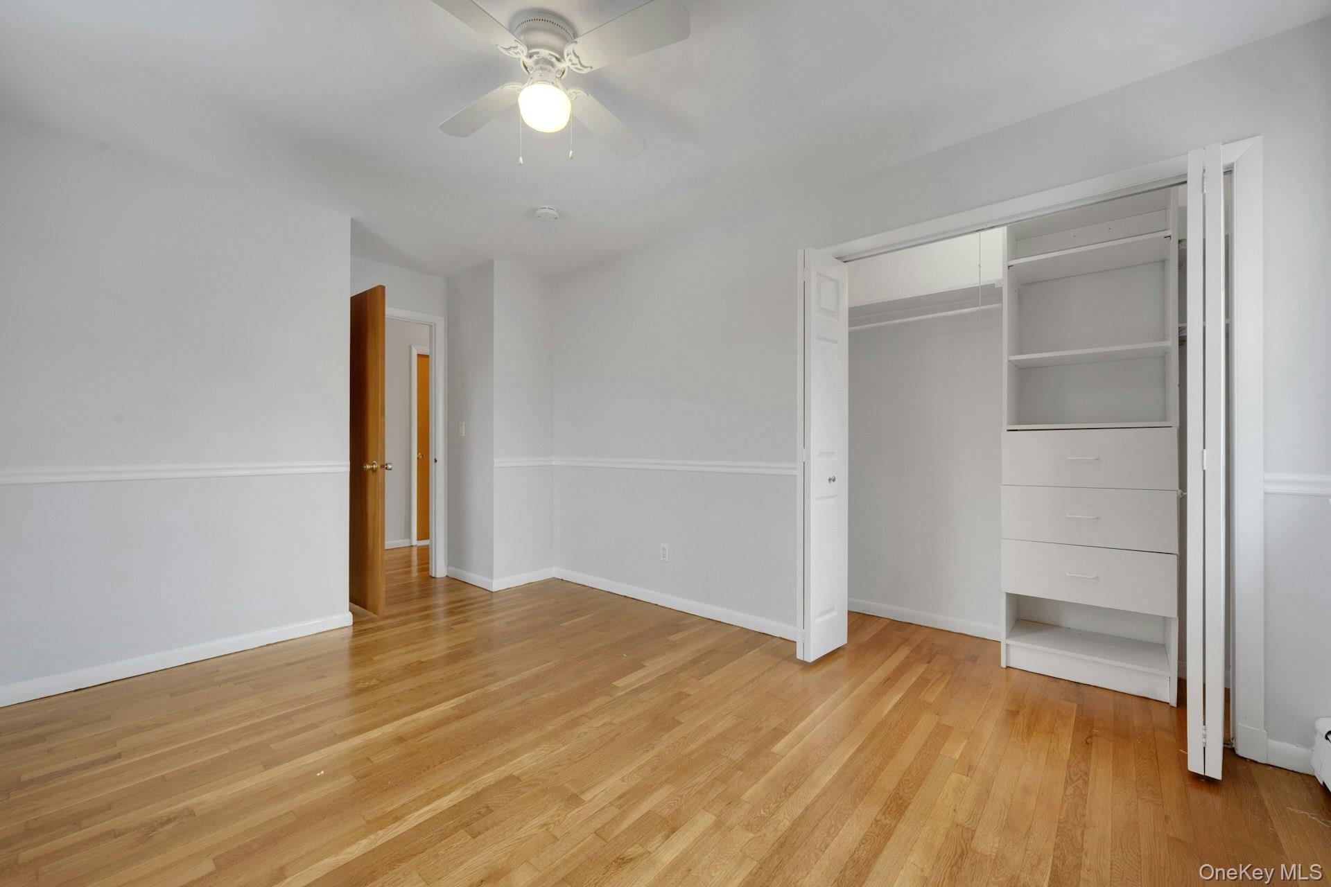 52 Post Place, Unit 2 Harrison, NY 10528 - Photo 14 of 23 an empty room with wooden floor and closet area