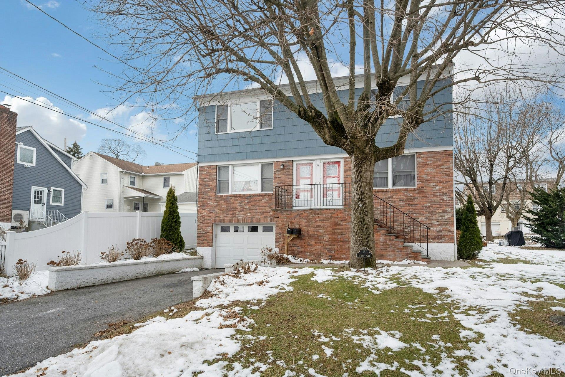 52 Post Place, Unit 2 Harrison, NY 10528 - Photo 22 of 23 a front view of a house with a yard
