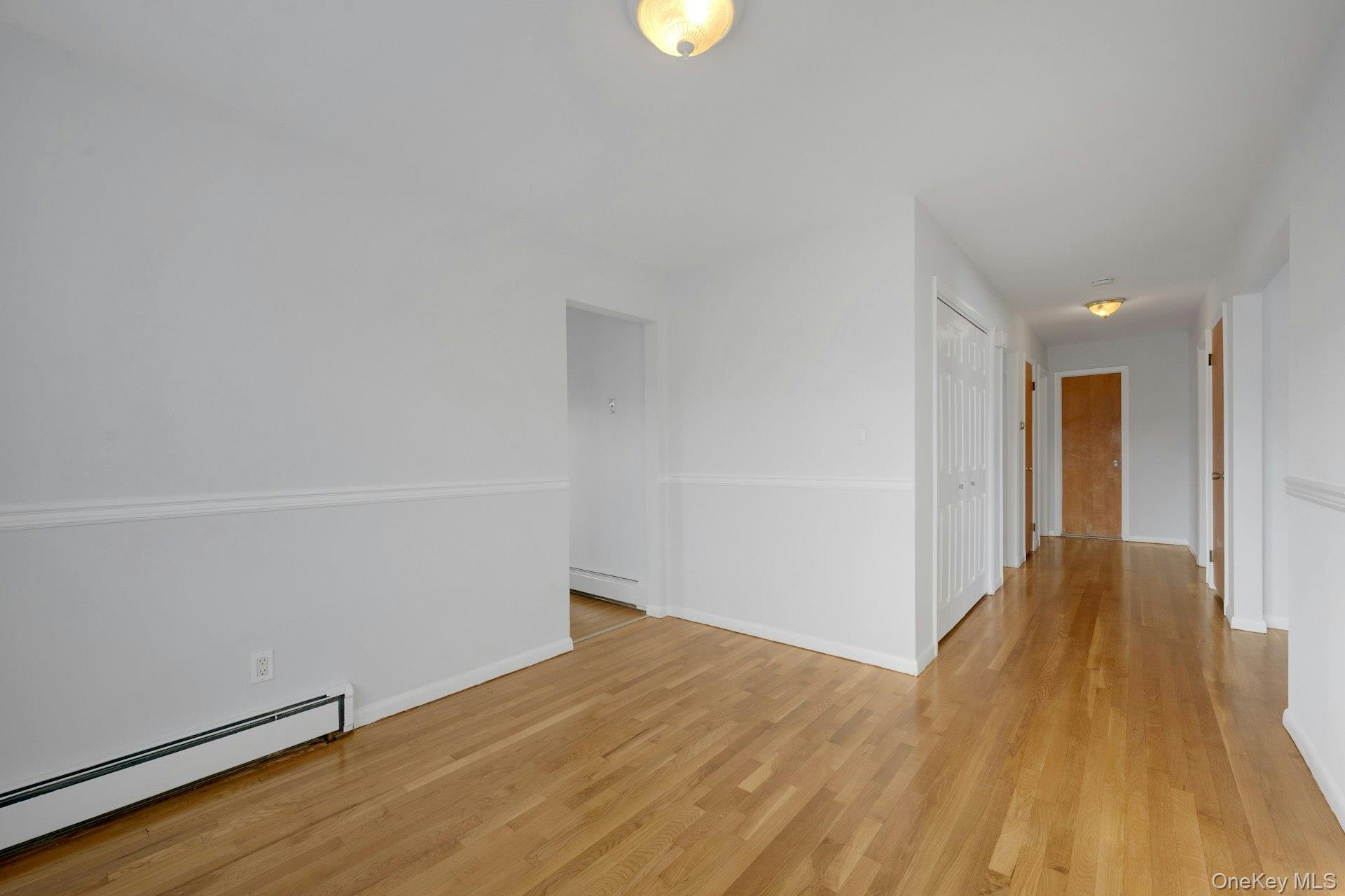 52 Post Place, Unit 2 Harrison, NY 10528 - Photo 7 of 23 a view of an empty room with wooden floor