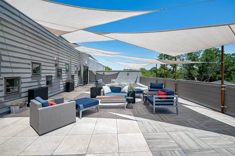 a outdoor living space with patio furniture and a garden