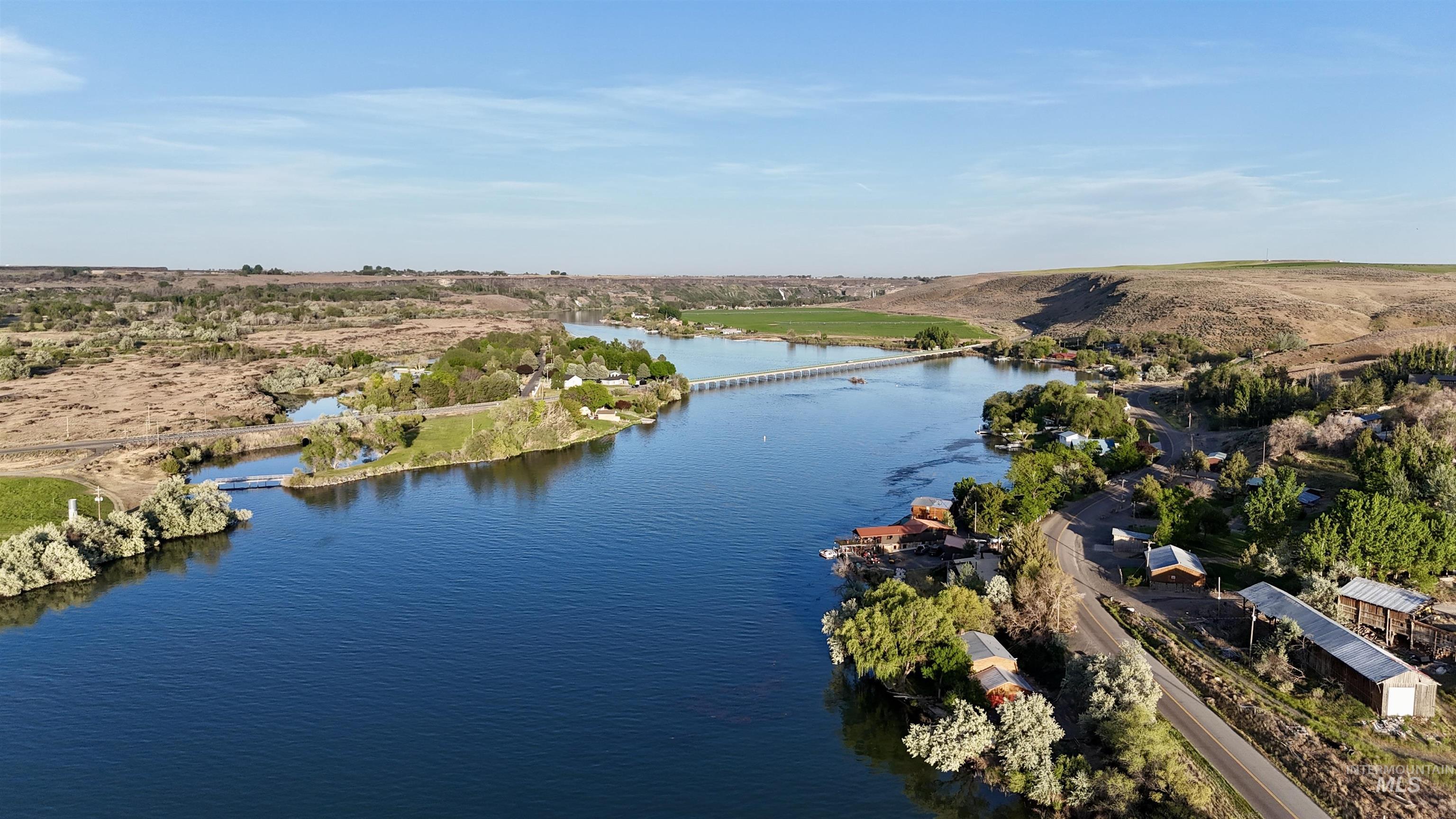 62 Bell Rapids Road Hagerman, ID 83332 - Photo 32 of 34 Expansive riverfront property featuring a serene waterway, surrounding natural landscape, and a long pedestrian bridge