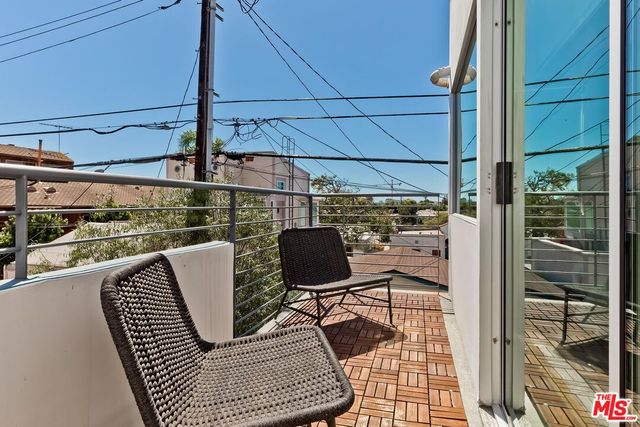 a bathroom with a double vanity sink a toilet and shower