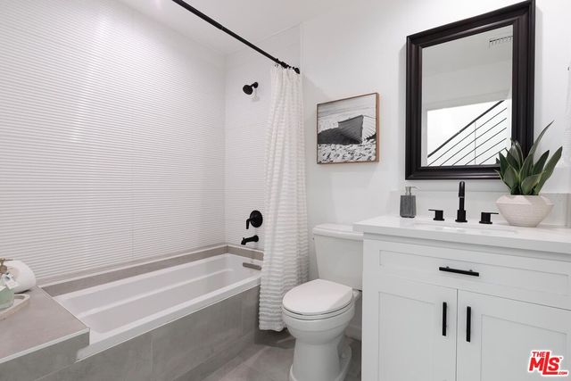 a view of a balcony with chairs and wooden floor