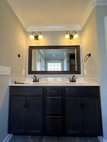 a bathroom with a double vanity sink and a mirror