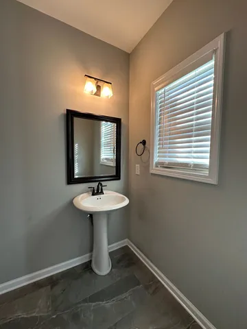 a bathroom with a sink toilet and mirror