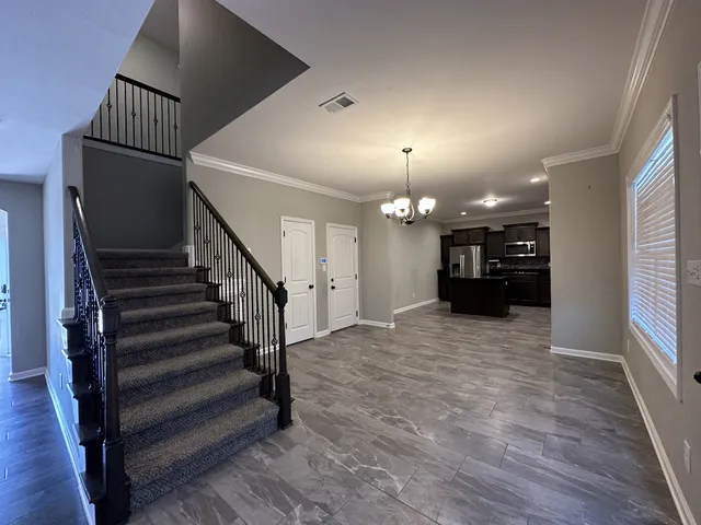 a view of entryway and hall with wooden floor