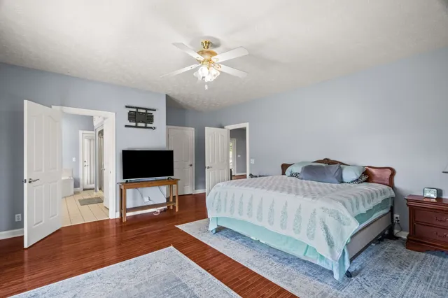 a bathroom with a double vanity sink mirror and bathtub