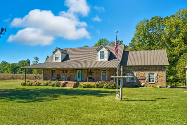 a front view of a house with a yard table and chairs