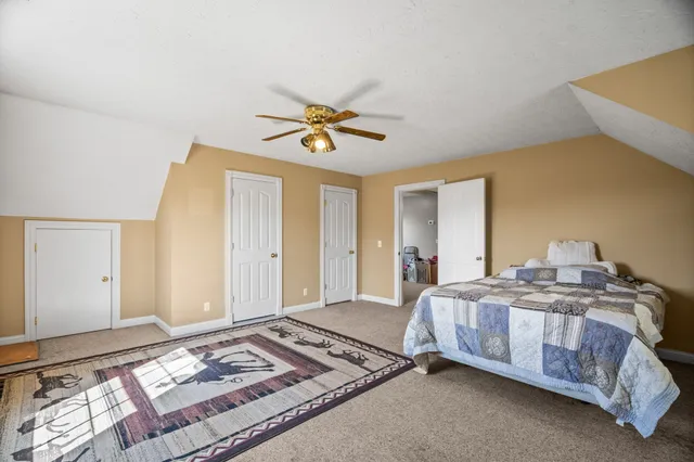 a spacious bedroom with a bed and a window