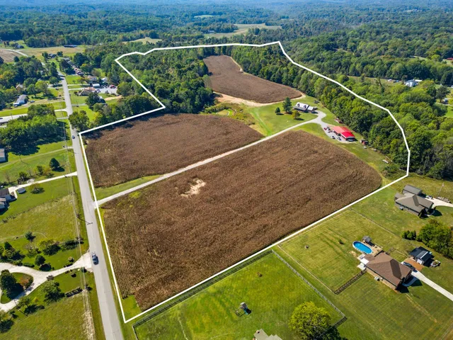 an aerial view of a houses with a yard