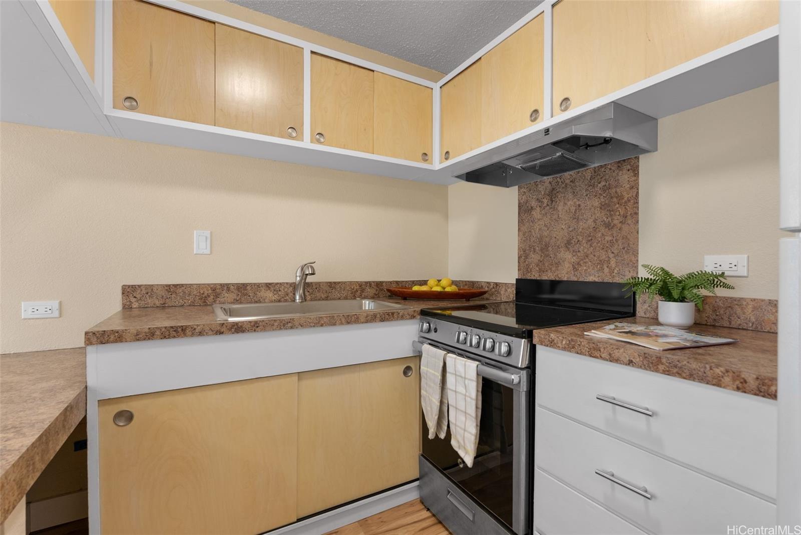 814 Kinau Street, Unit 401 Honolulu, HI 96813 - Photo 11 of 23 a kitchen with stainless steel appliances granite countertop a sink and a stove