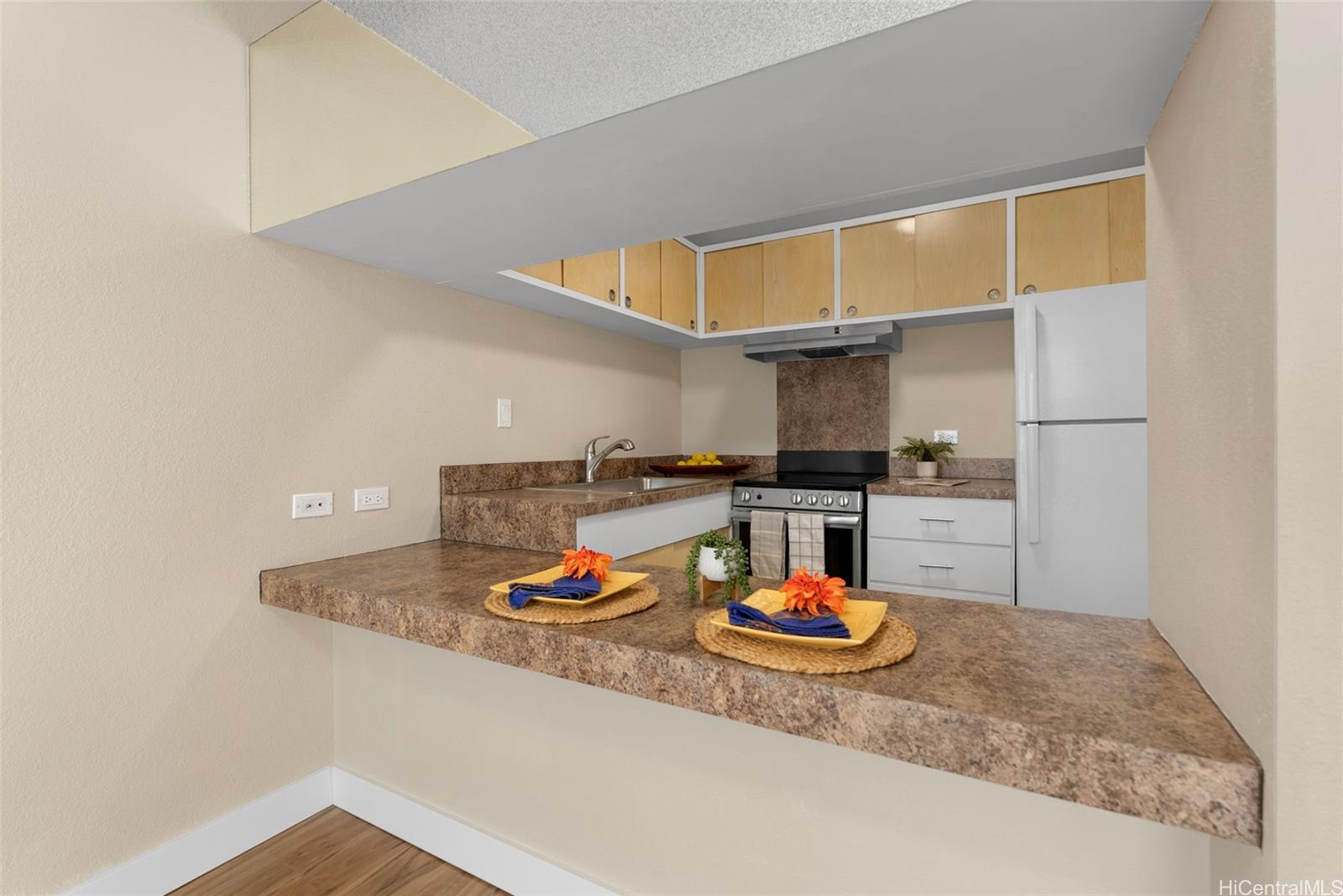 814 Kinau Street, Unit 401 Honolulu, HI 96813 - Photo 12 of 23 a kitchen with a table and chairs in it