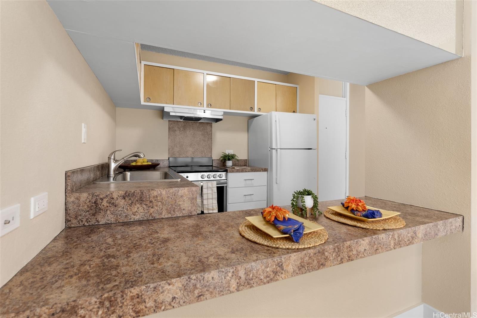 814 Kinau Street, Unit 401 Honolulu, HI 96813 - Photo 13 of 23 a kitchen with stainless steel appliances granite countertop a sink refrigerator and stove