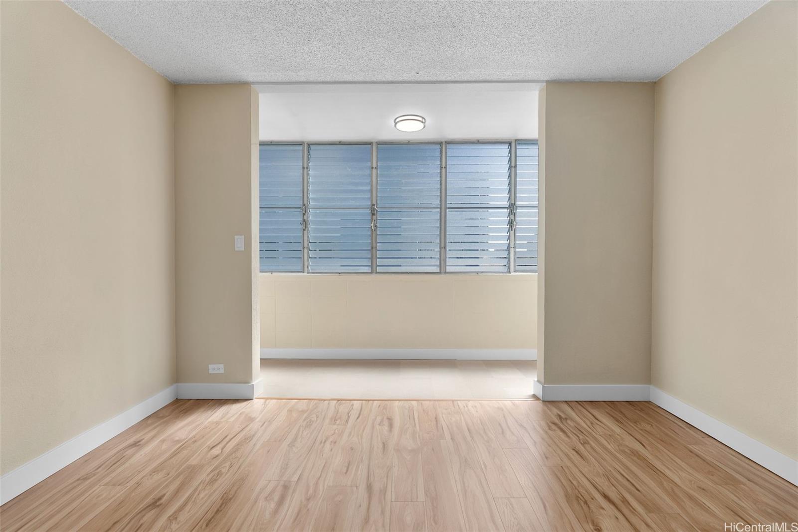 814 Kinau Street, Unit 401 Honolulu, HI 96813 - Photo 8 of 23 an empty room with wooden floor and windows