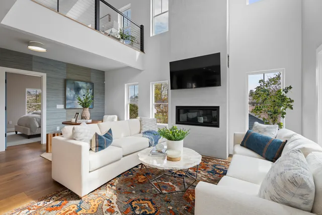 a living room with furniture a flat screen tv and a fireplace